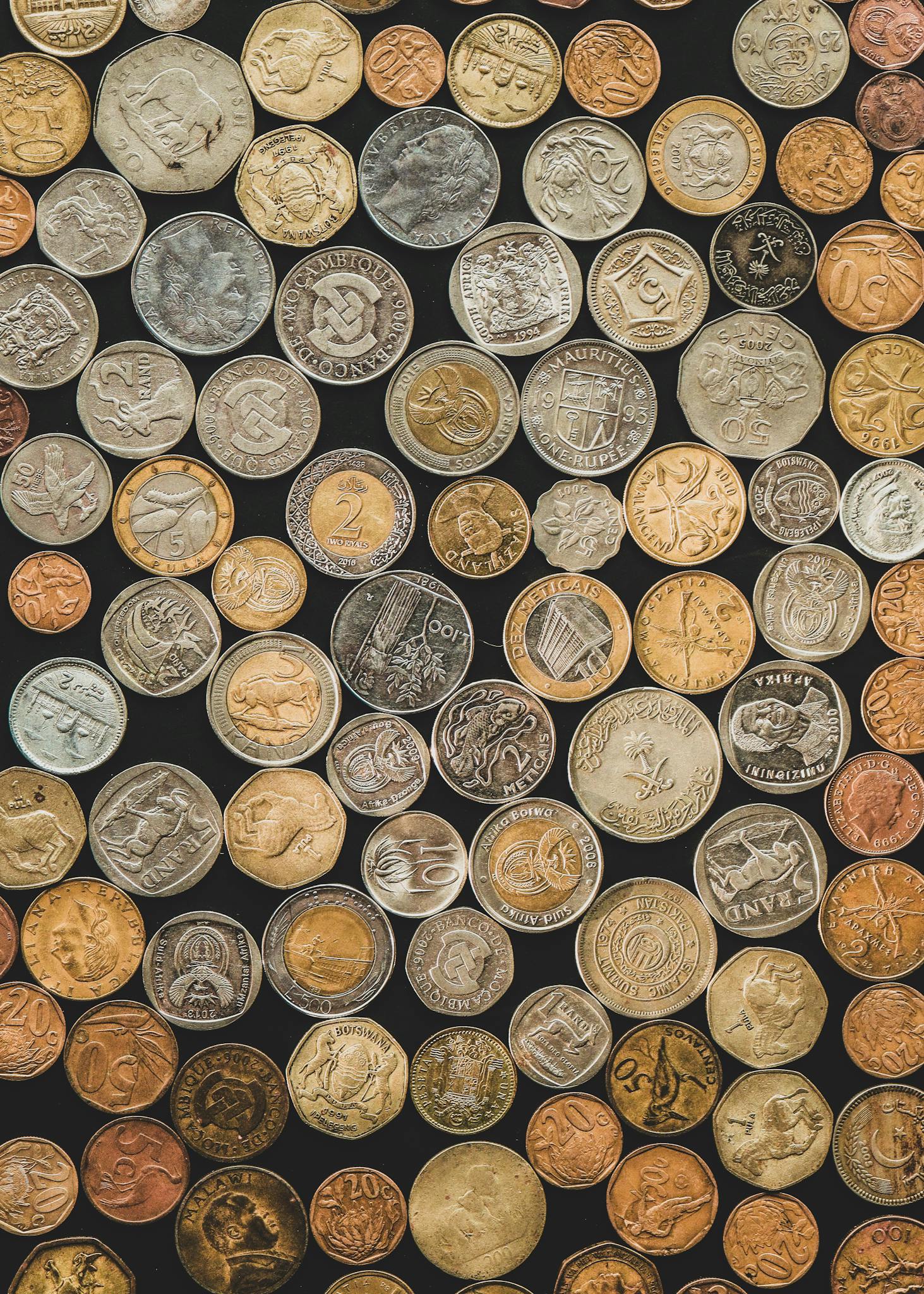 A Diverse Collection Of International Coins Arranged