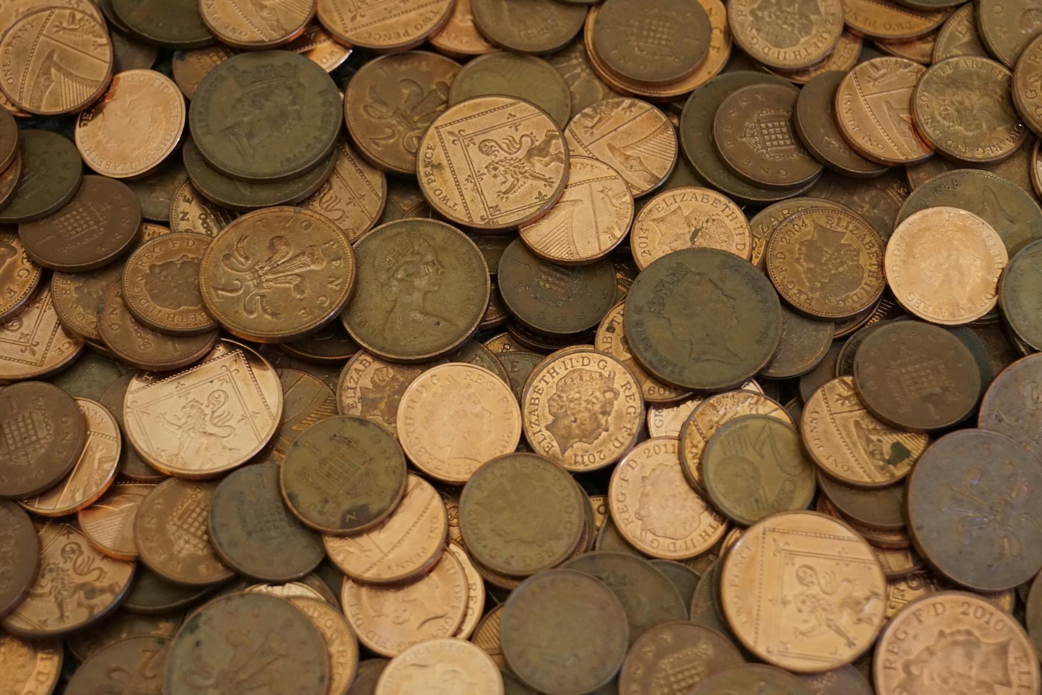 An assortment of vintage coins in varying colors and designs, showcasing historical currency.