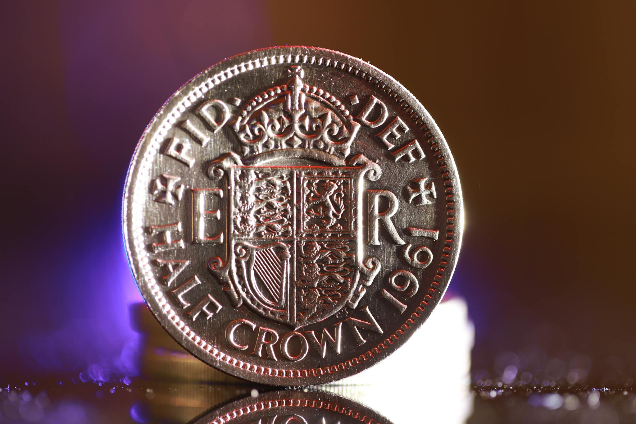 Detailed image of a 1961 British half crown coin reflecting vivid light.
